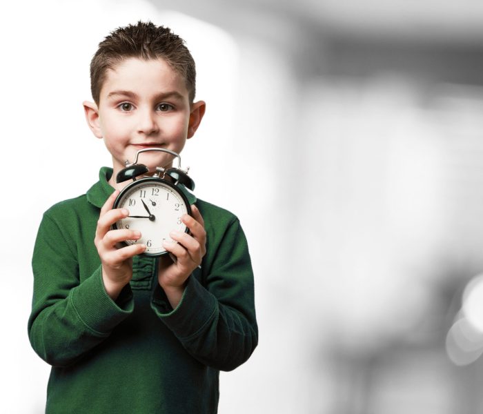 little kid with an alarm-clock