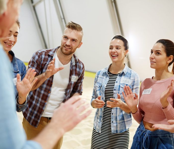 Team of young participants sharing ideas of how to be a success and win the competition